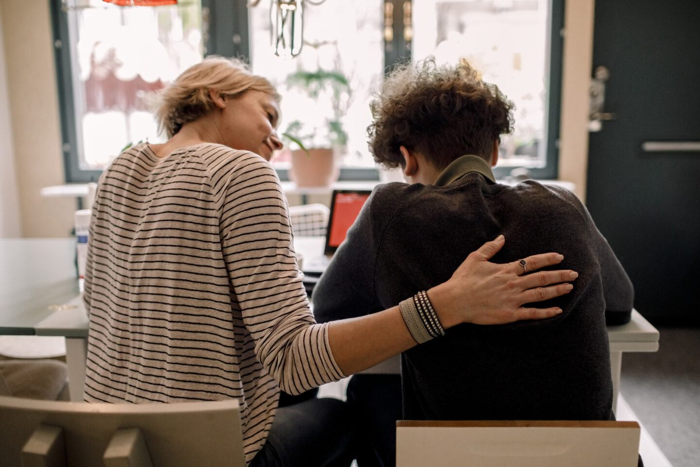 Raising teens: mom and son sitting together