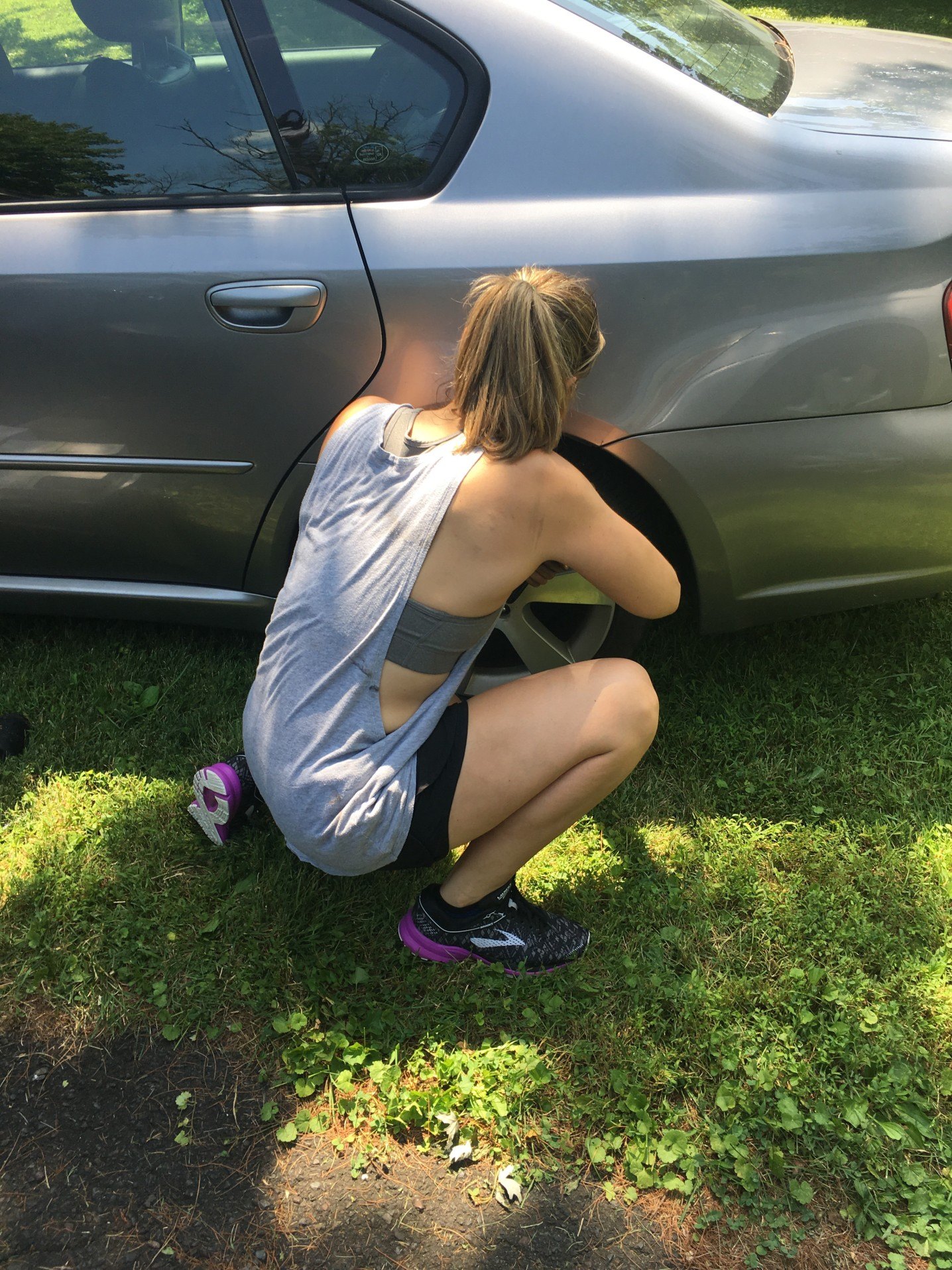 woman changing her tire professional woman independent millennial life working on car natural light t20 kR1yYR Motherly