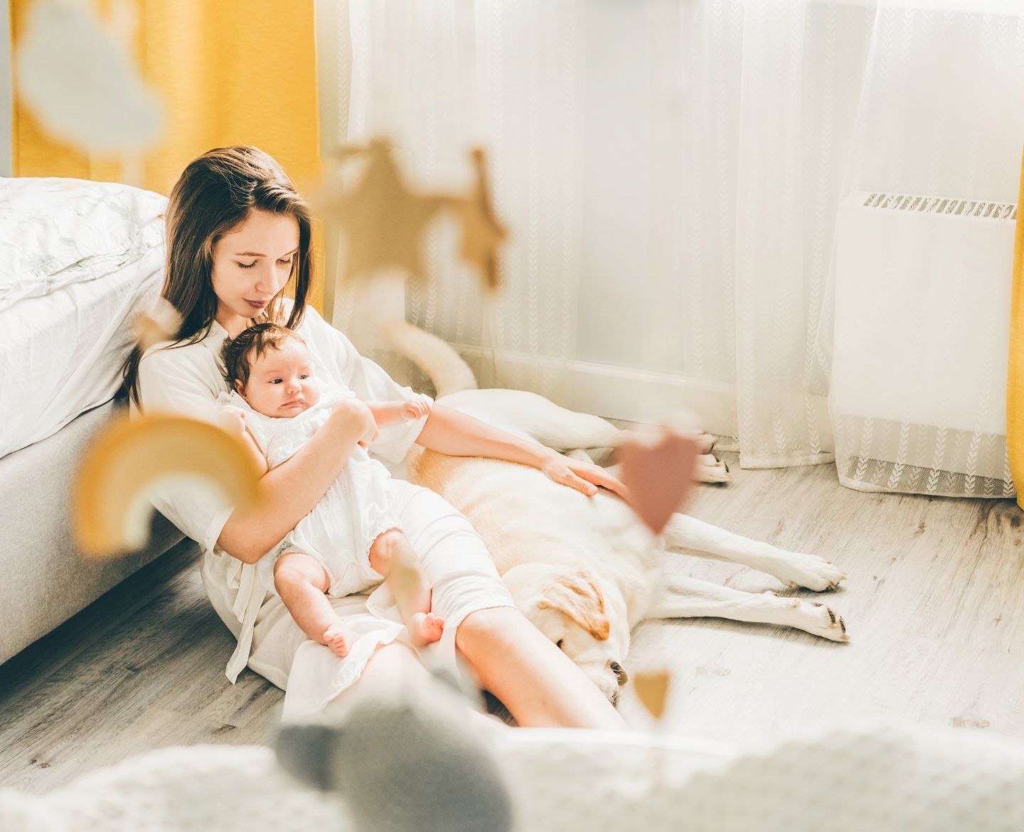 sleep training: mother sitting on floor holding baby