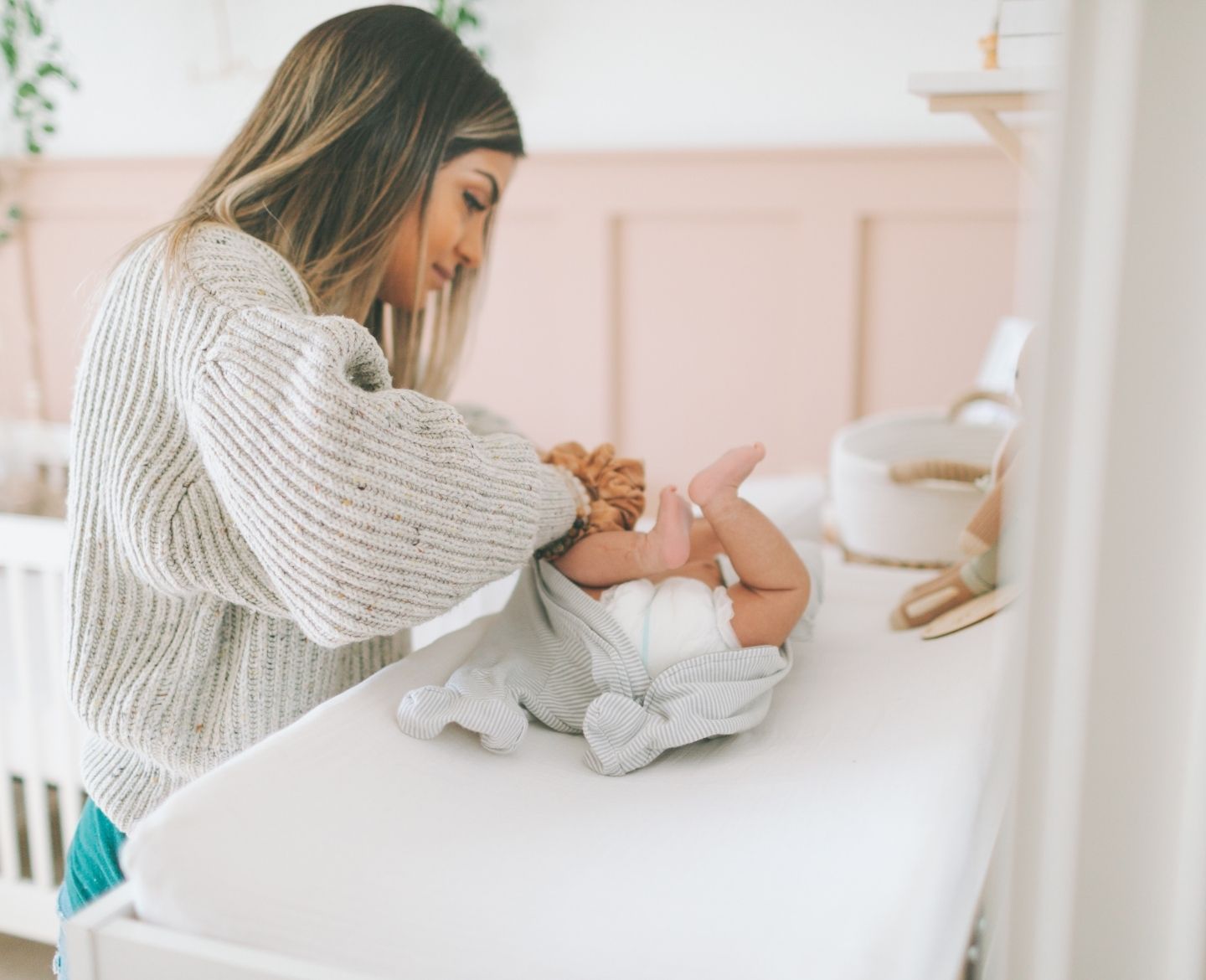 mom changing baby's diaper