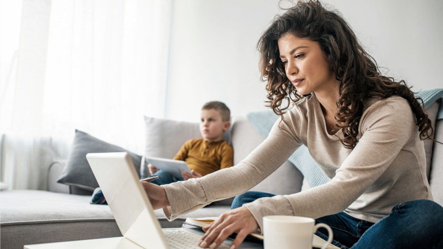 woman working with child - motherly's data on the great resignation