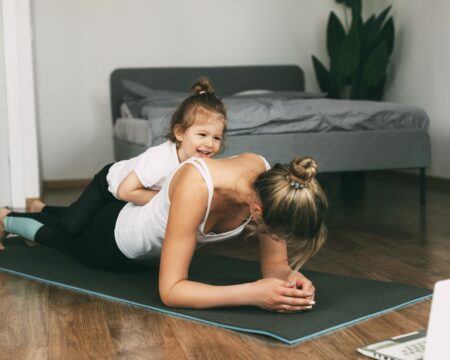 a young sports mom and a girl together do exercises at home healthy development of parents and t20 ypN3w0 Motherly