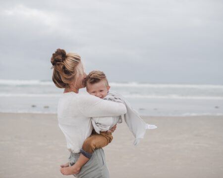 little boy in his moms arms pretending to be a superhero with a cape t20 omV46e Motherly