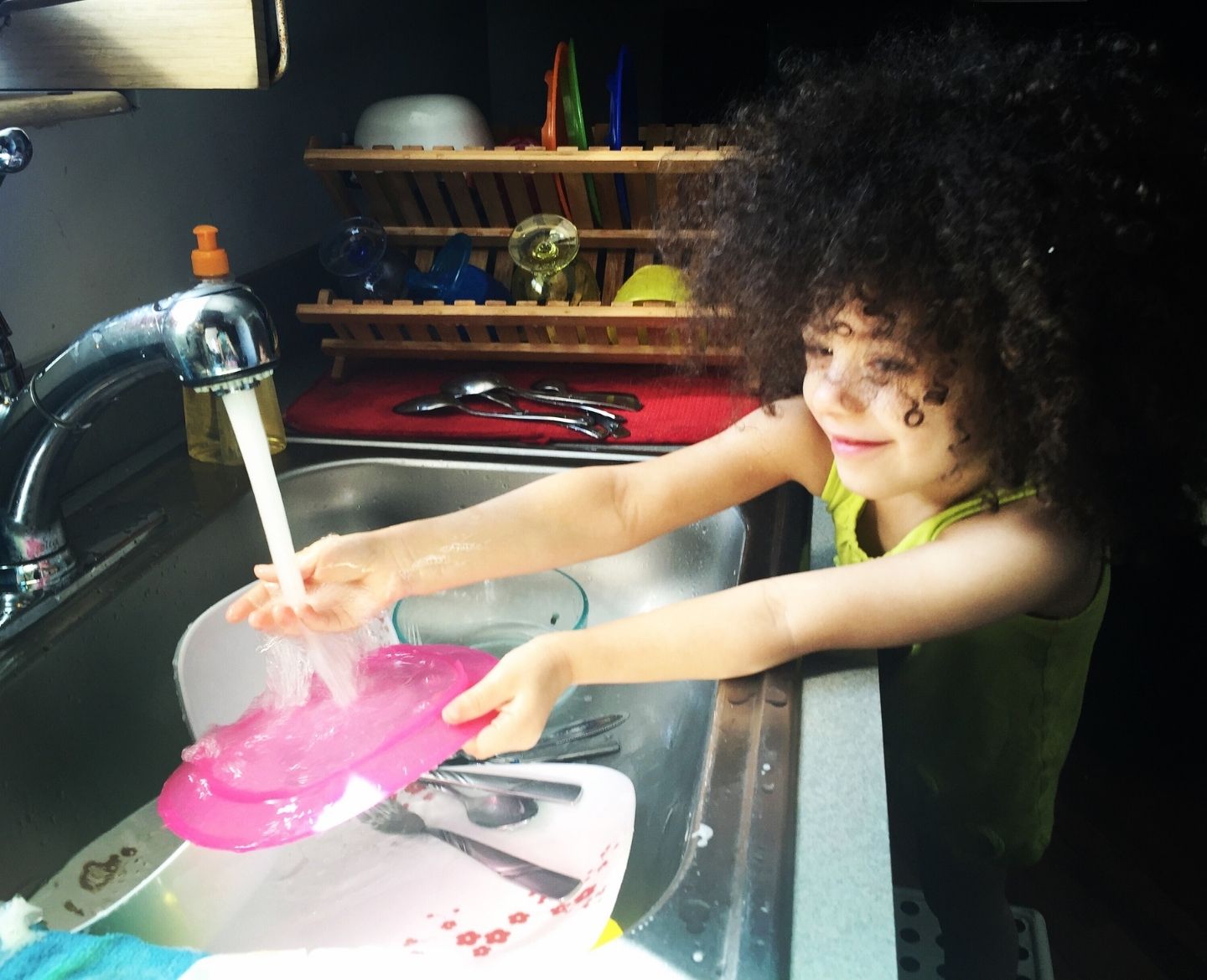 stop nagging chores: young child doing dishes