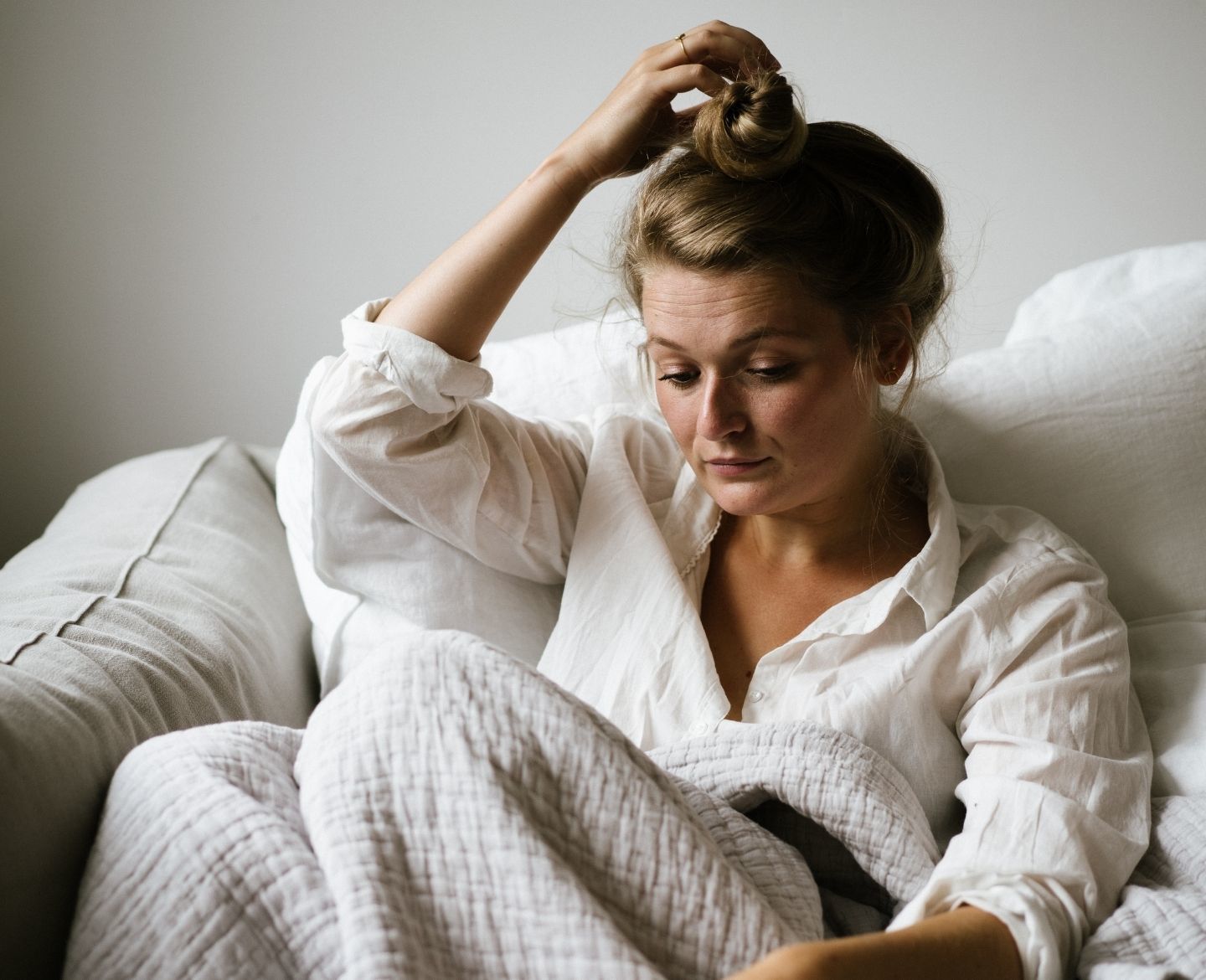 woman sitting on sofa looking down