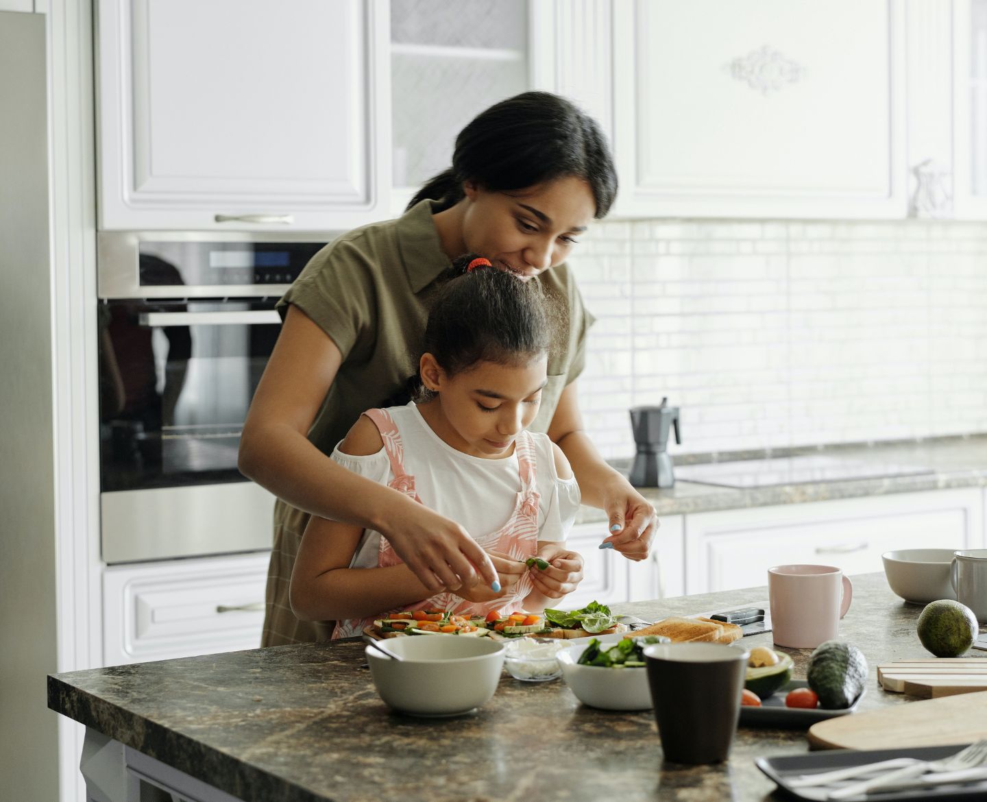 vegetarian kids: mother and daughter cooking in kitchen