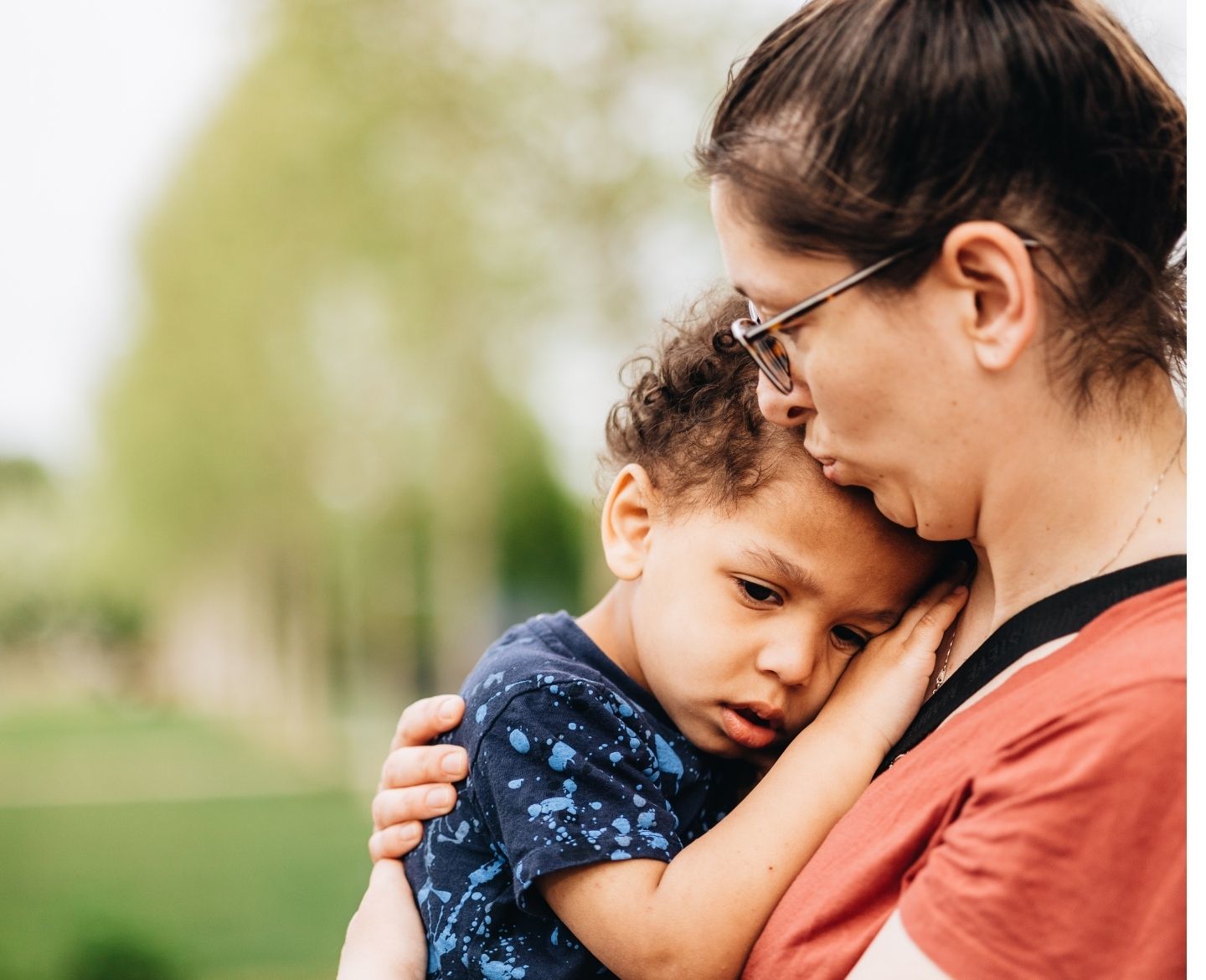 mother holding and kissing son