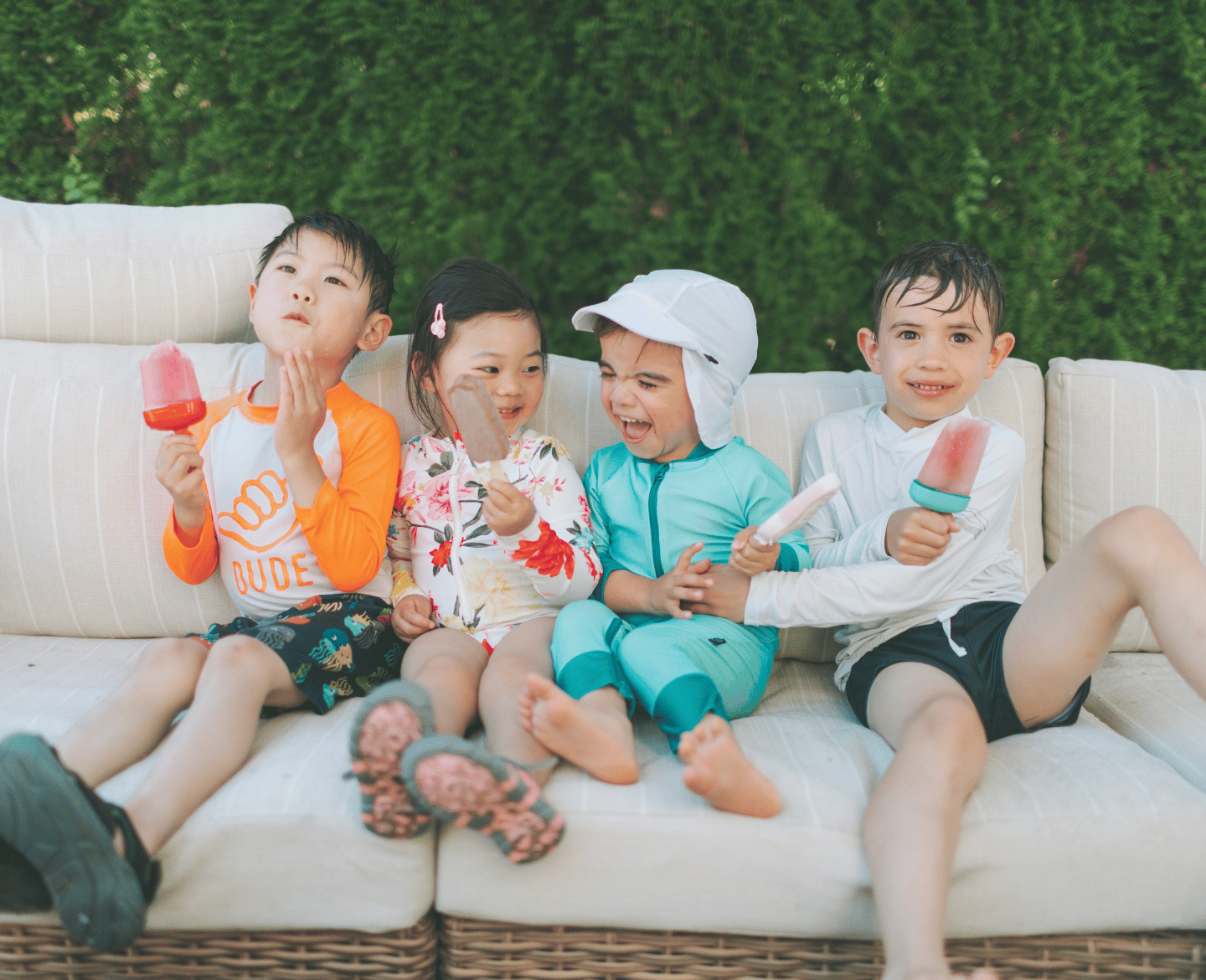 four kids eating popsicles