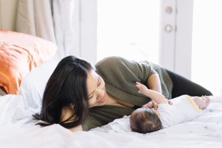 mom laying on bed with a newborn