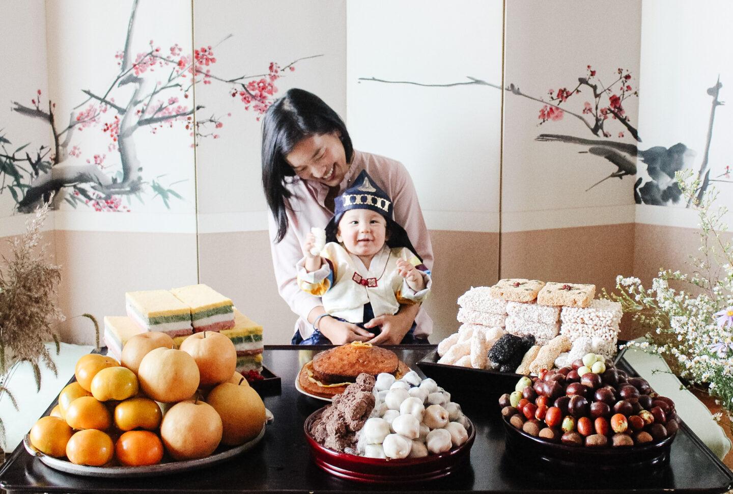 mom and child above a table of food