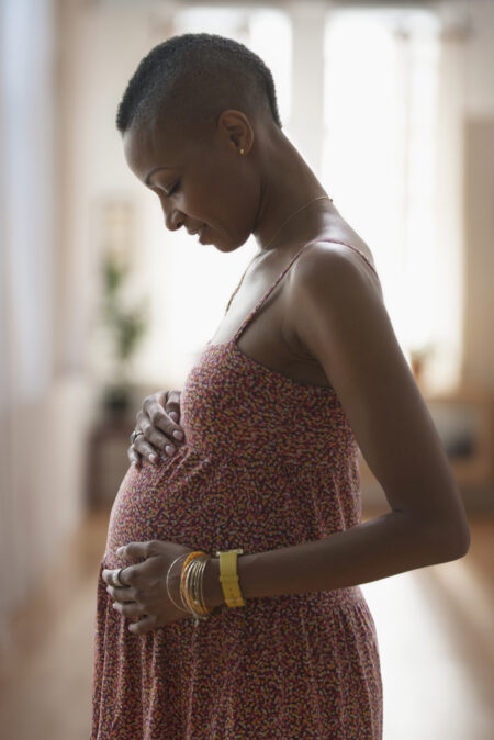 Pregnant woman touching her belly