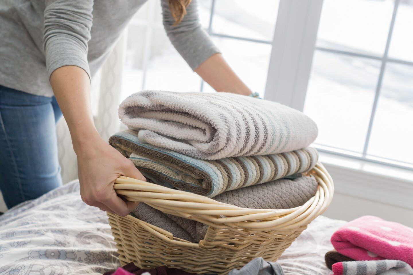 woman carrying a basket of laundry
