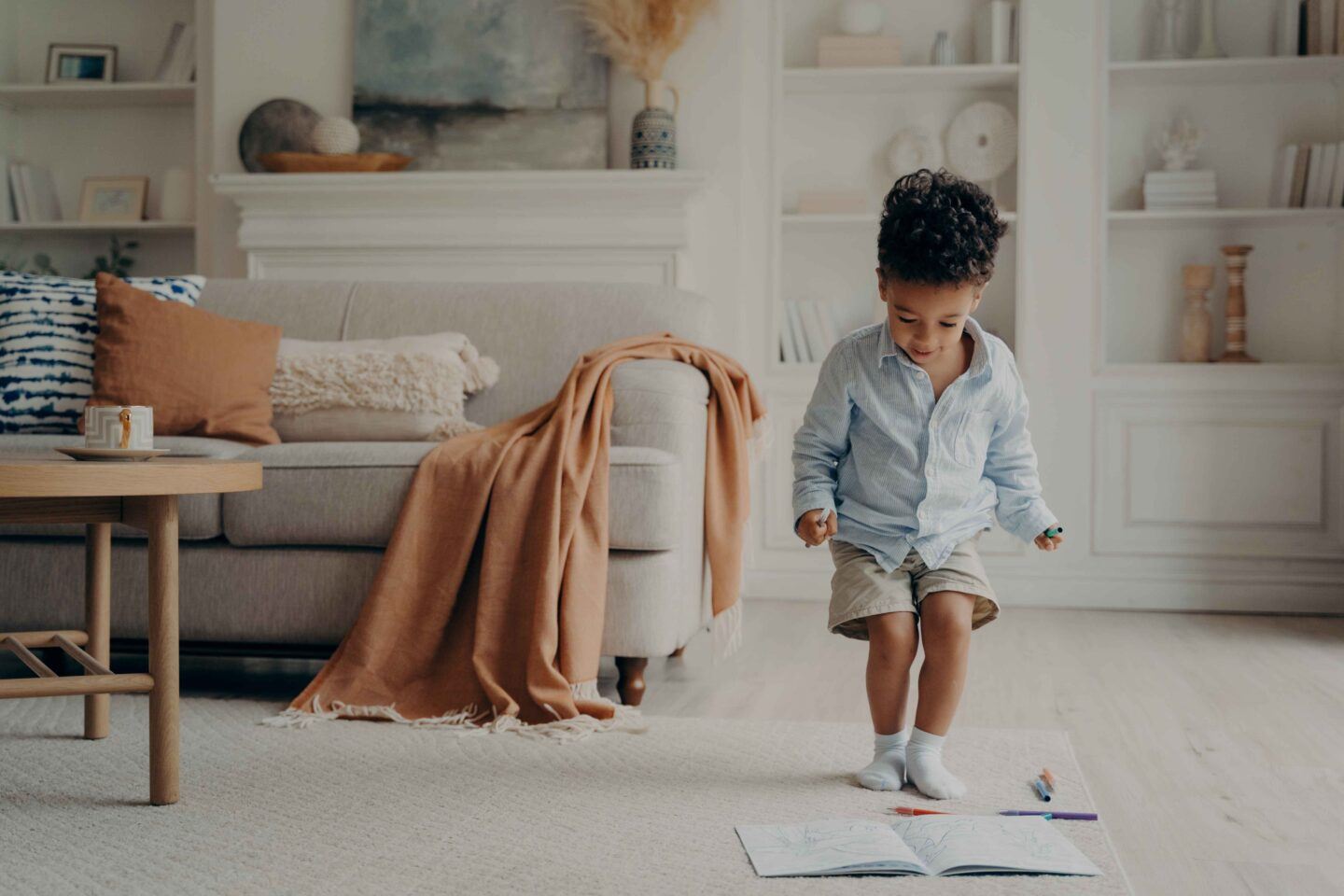 Happy mixed race little boy enjoying playing alone