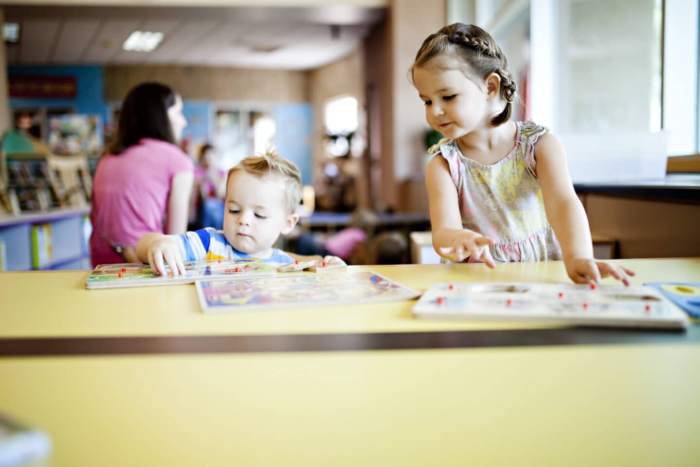 two kids working on puzzles at the library t20 pl1V18 Motherly