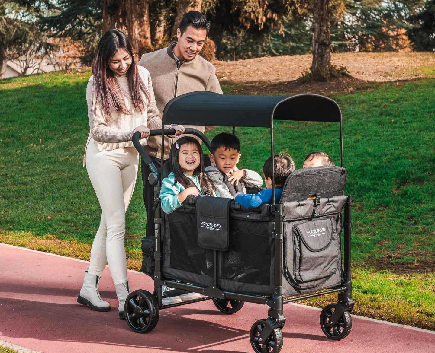 family walking with kids in stroller wagon