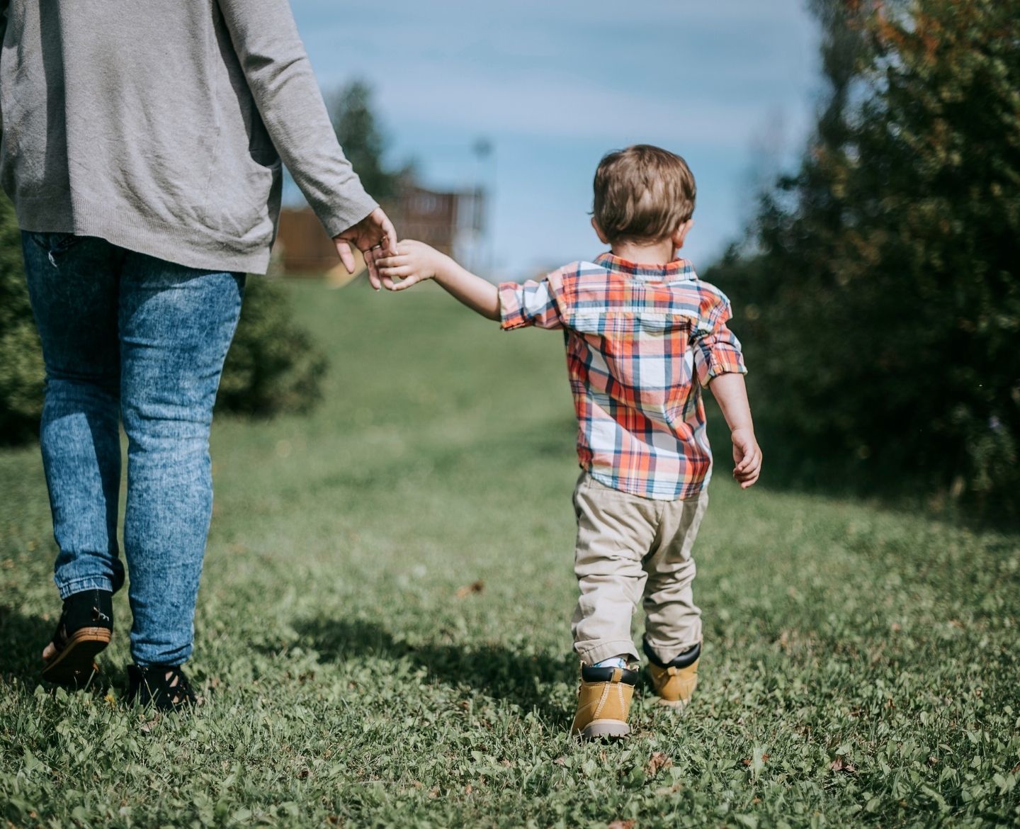 mom holding son's hand, walking