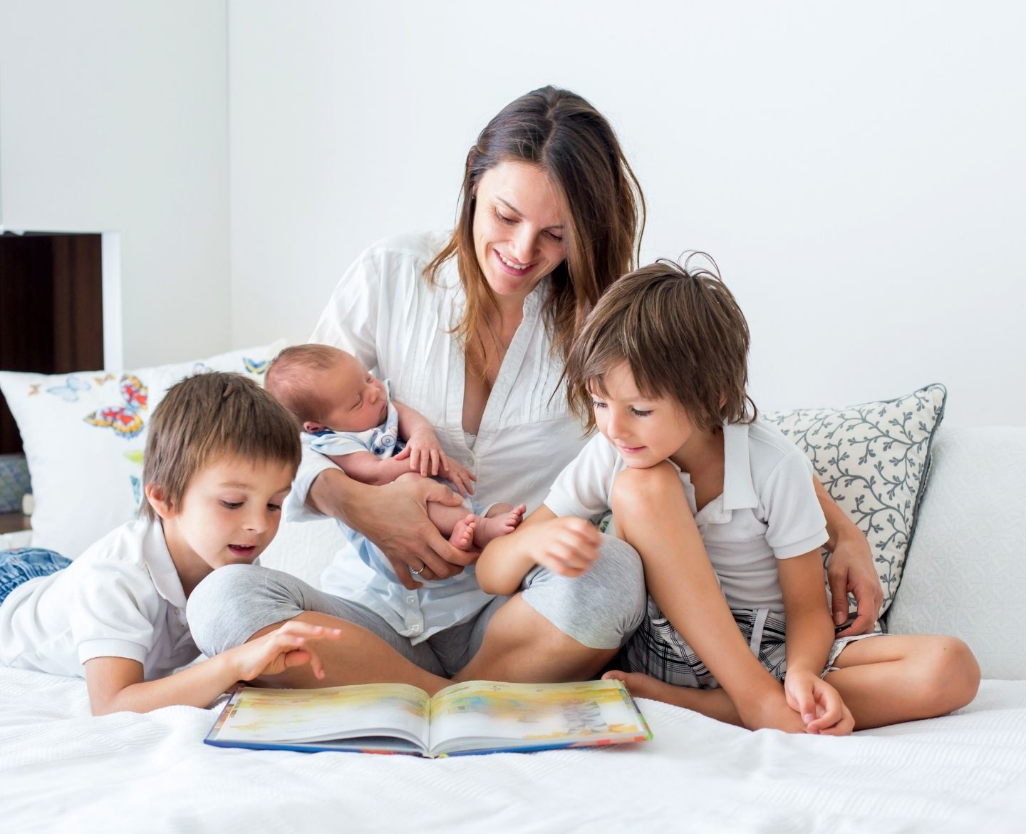 mom reading with three kids