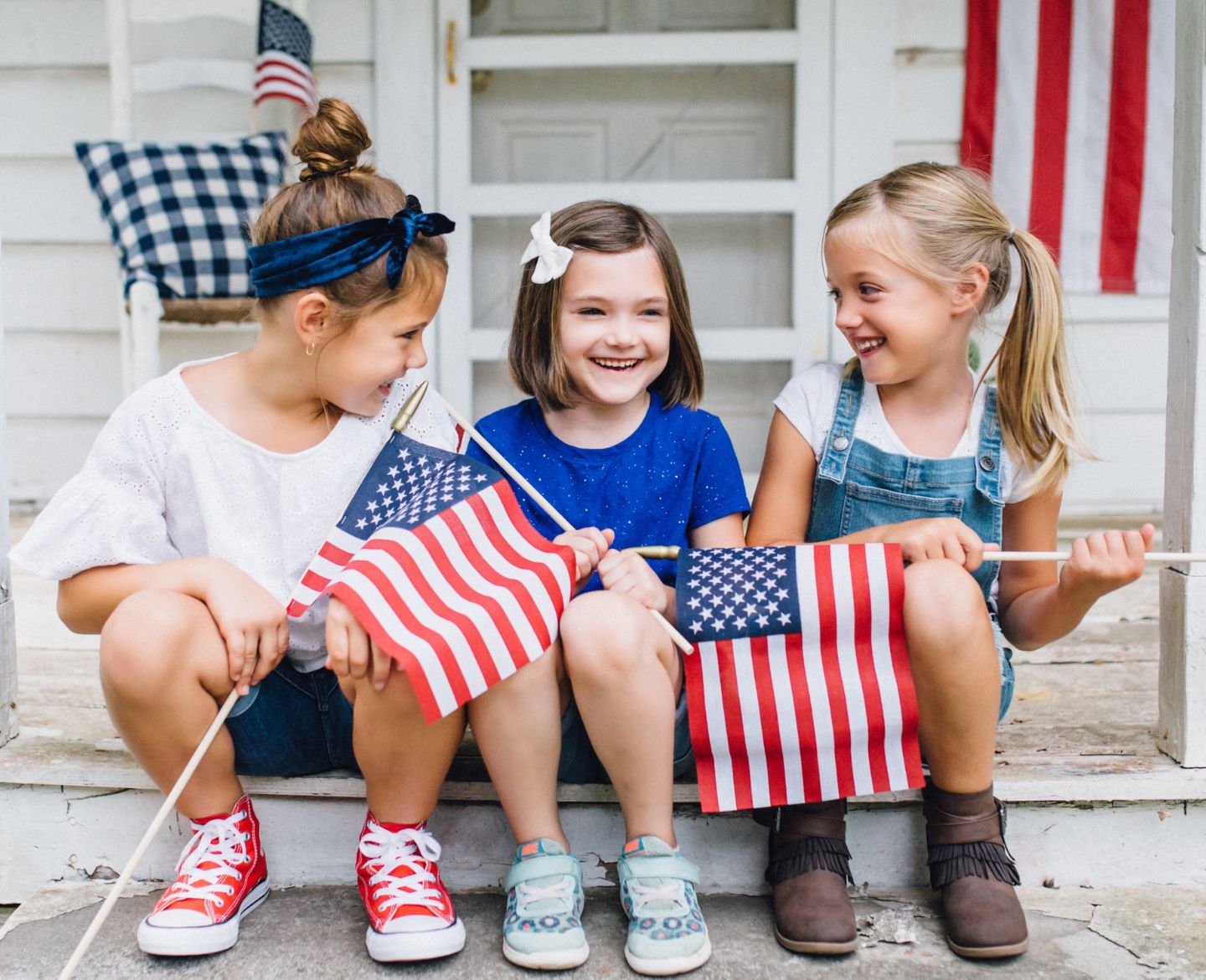 kids holding american flags Motherly