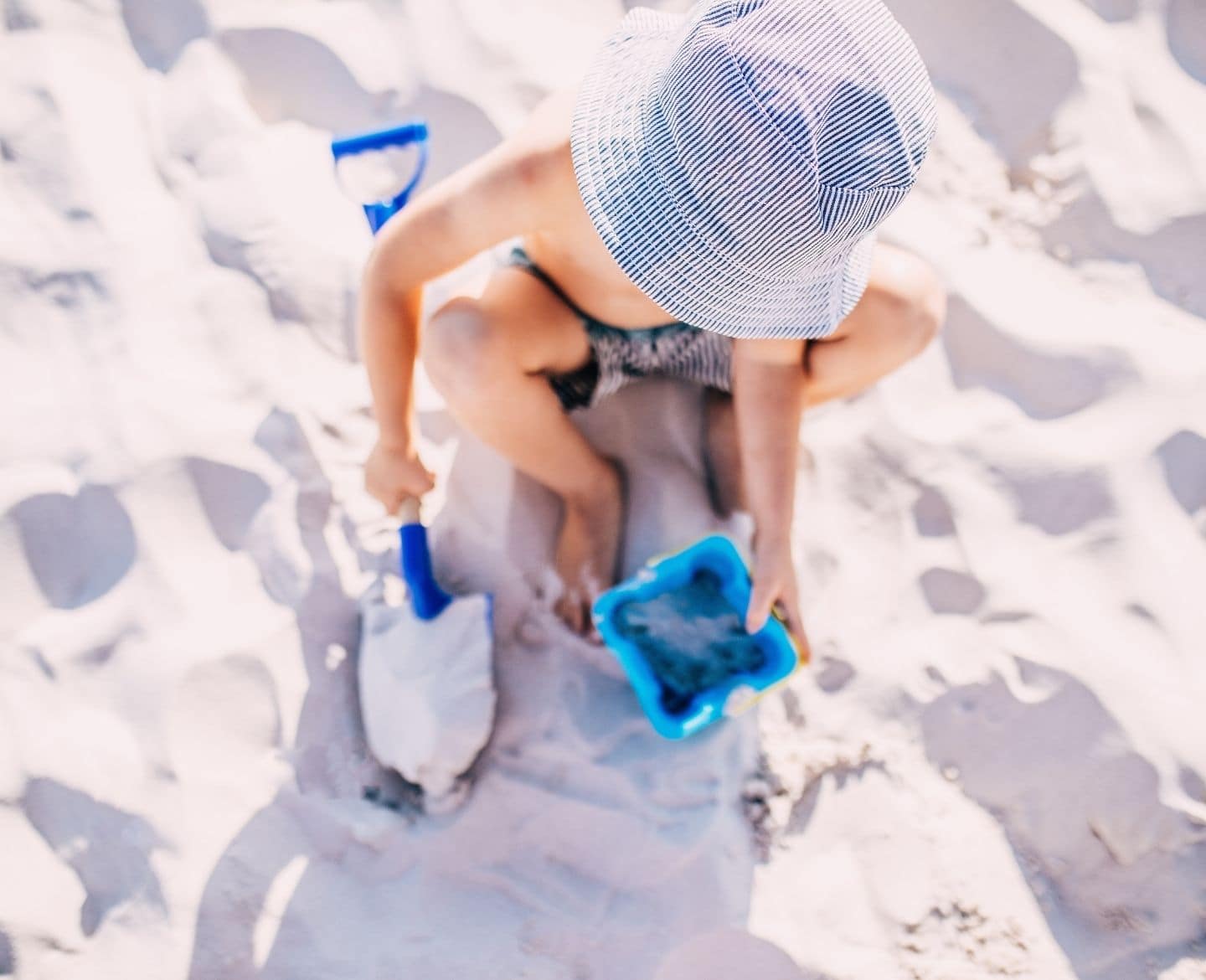 little boy playing in the sand