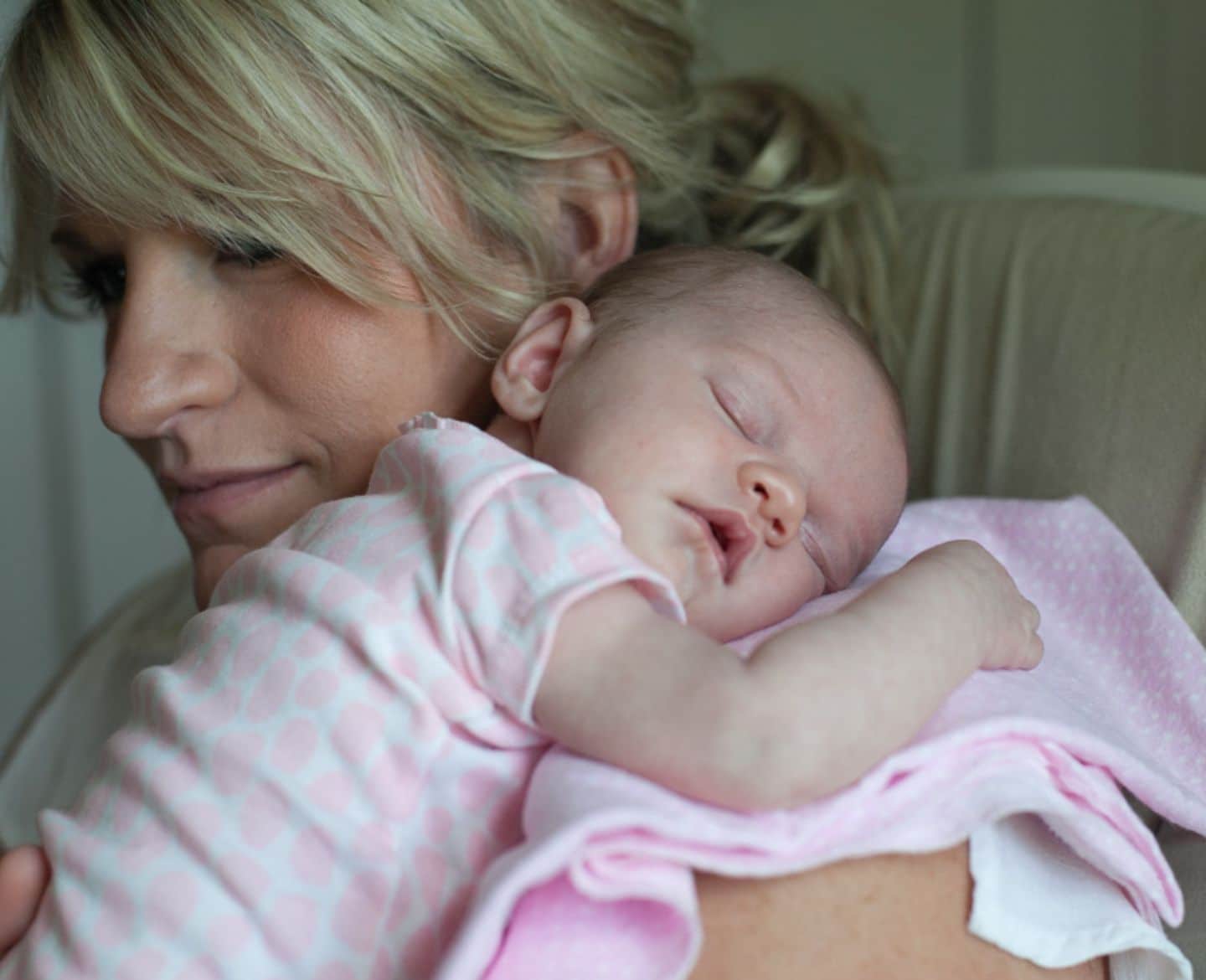 mom holding sleeping baby