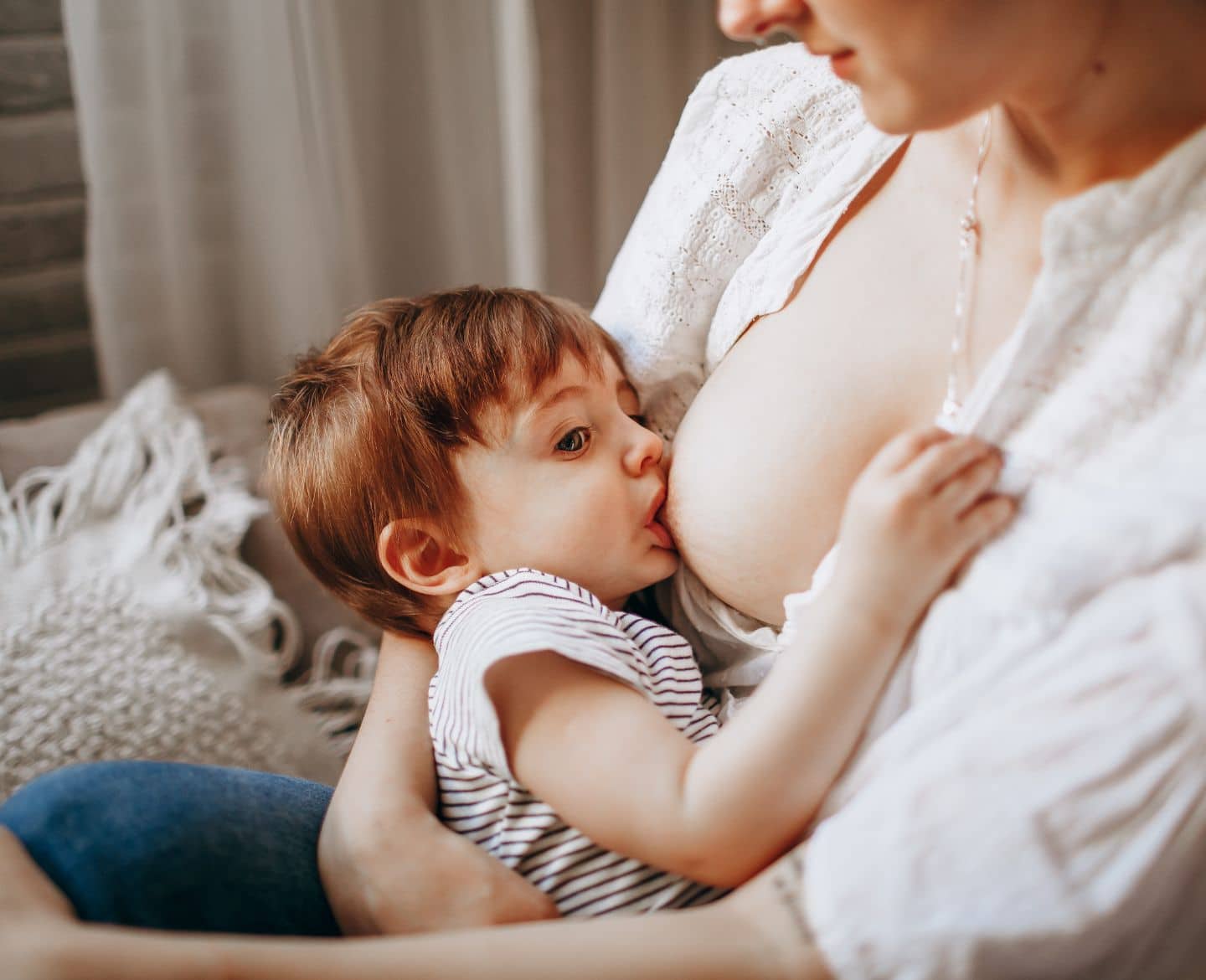 mother breastfeeding toddler