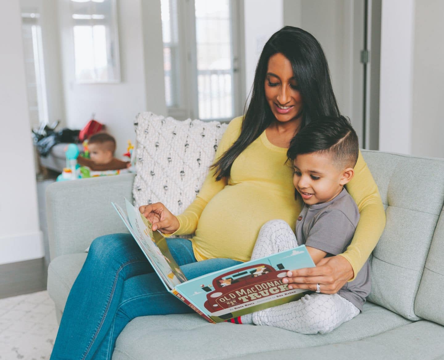 pregnant mom reading to son