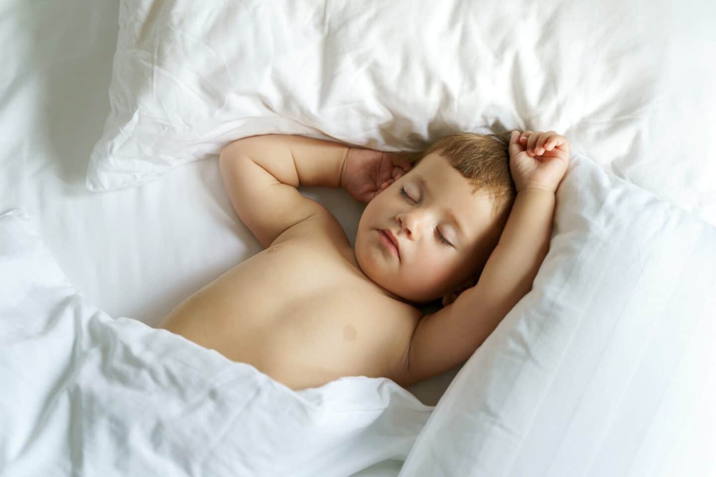 toddler sleeping in bed