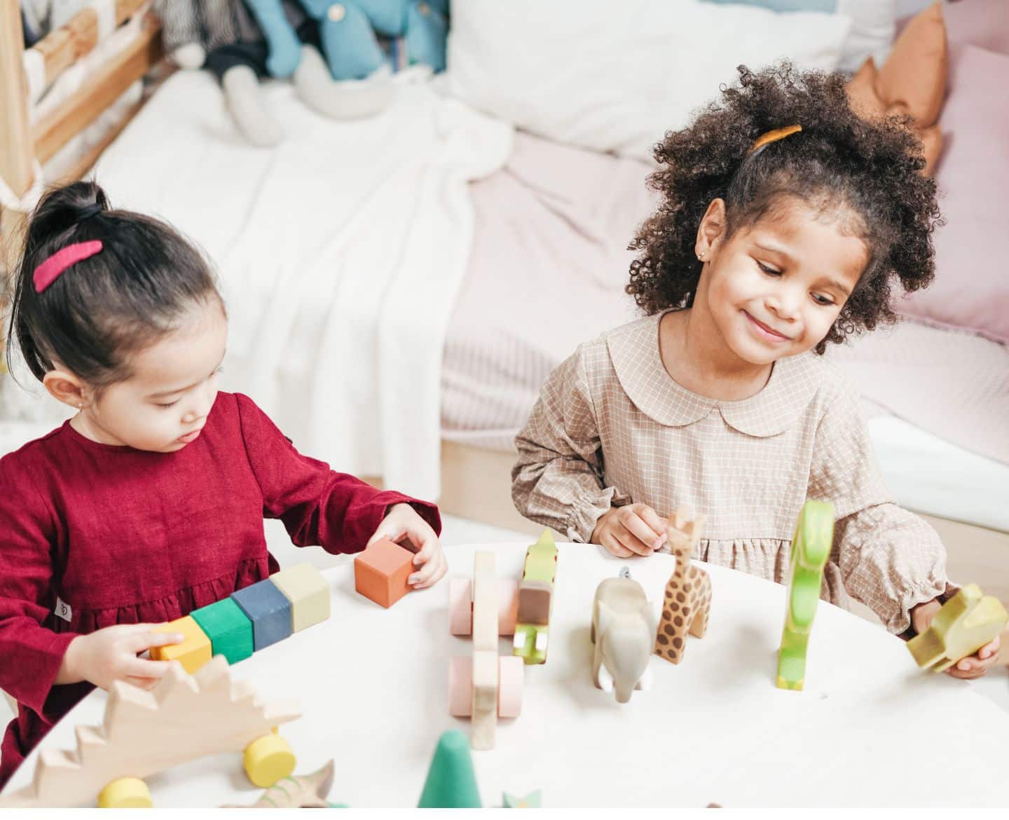 Two girls sitting at a table playing with blocks - Amazon Prime Day Toys