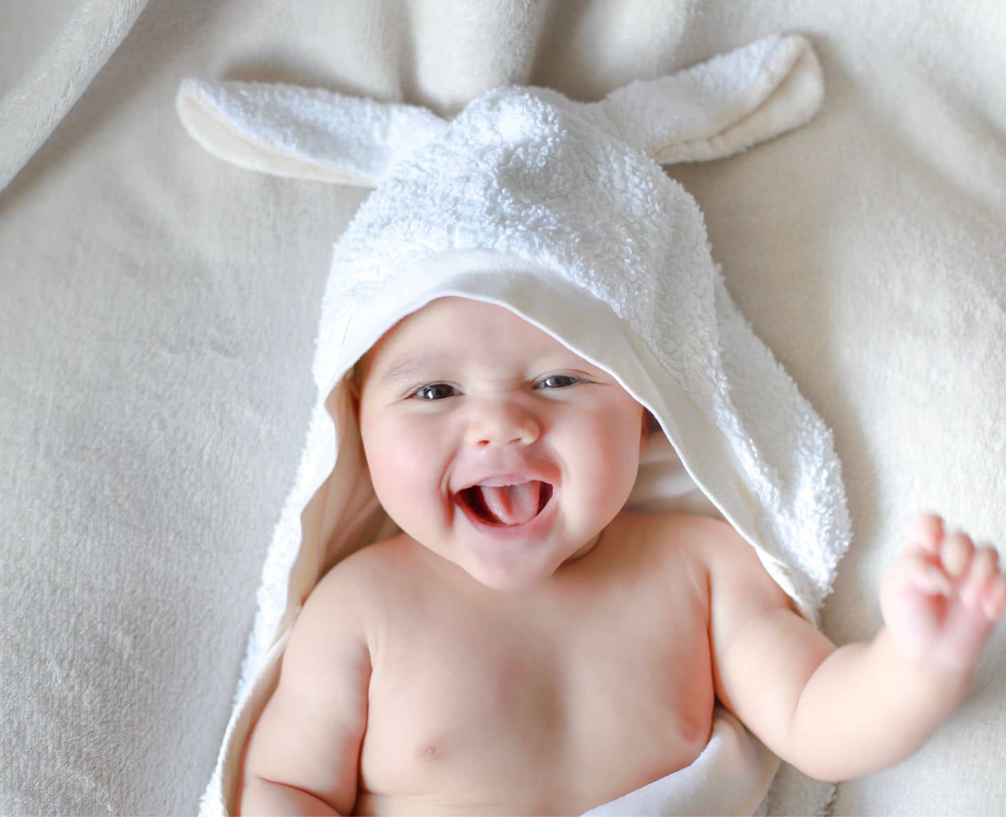 baby in towel smiling