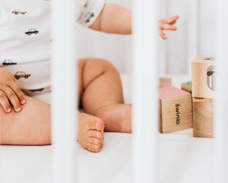 baby toes in a crib with blocks