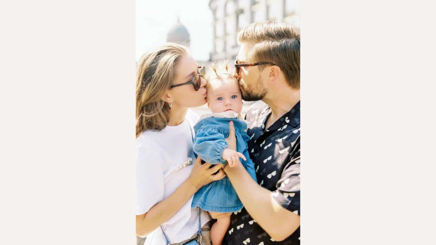 couple kissing baby