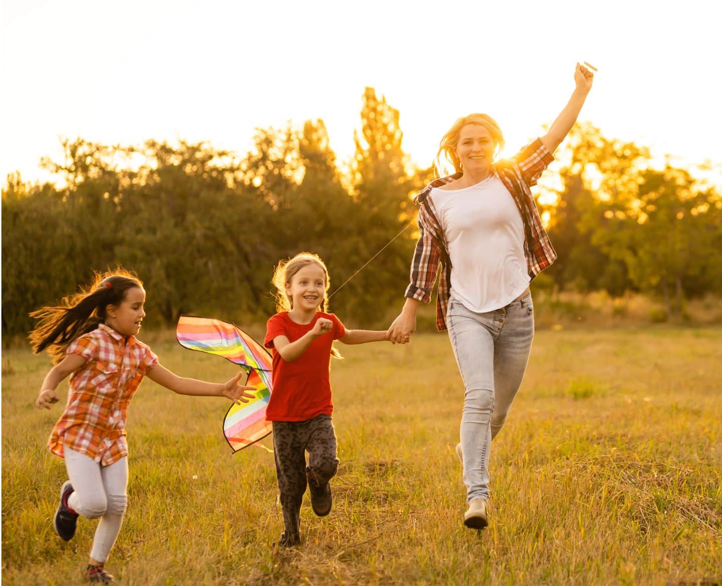 mom and kids running in a park