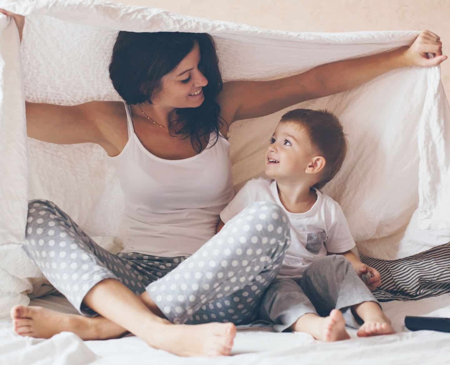 mom and son under blanket