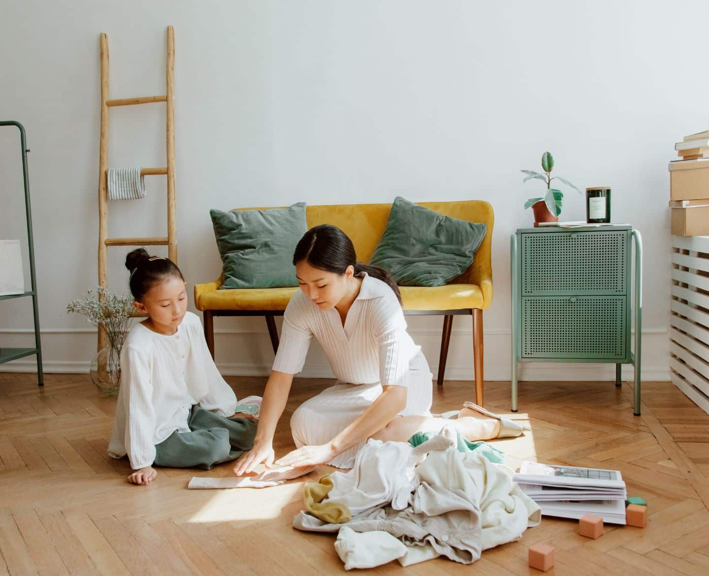 mom and daughter folding clothes