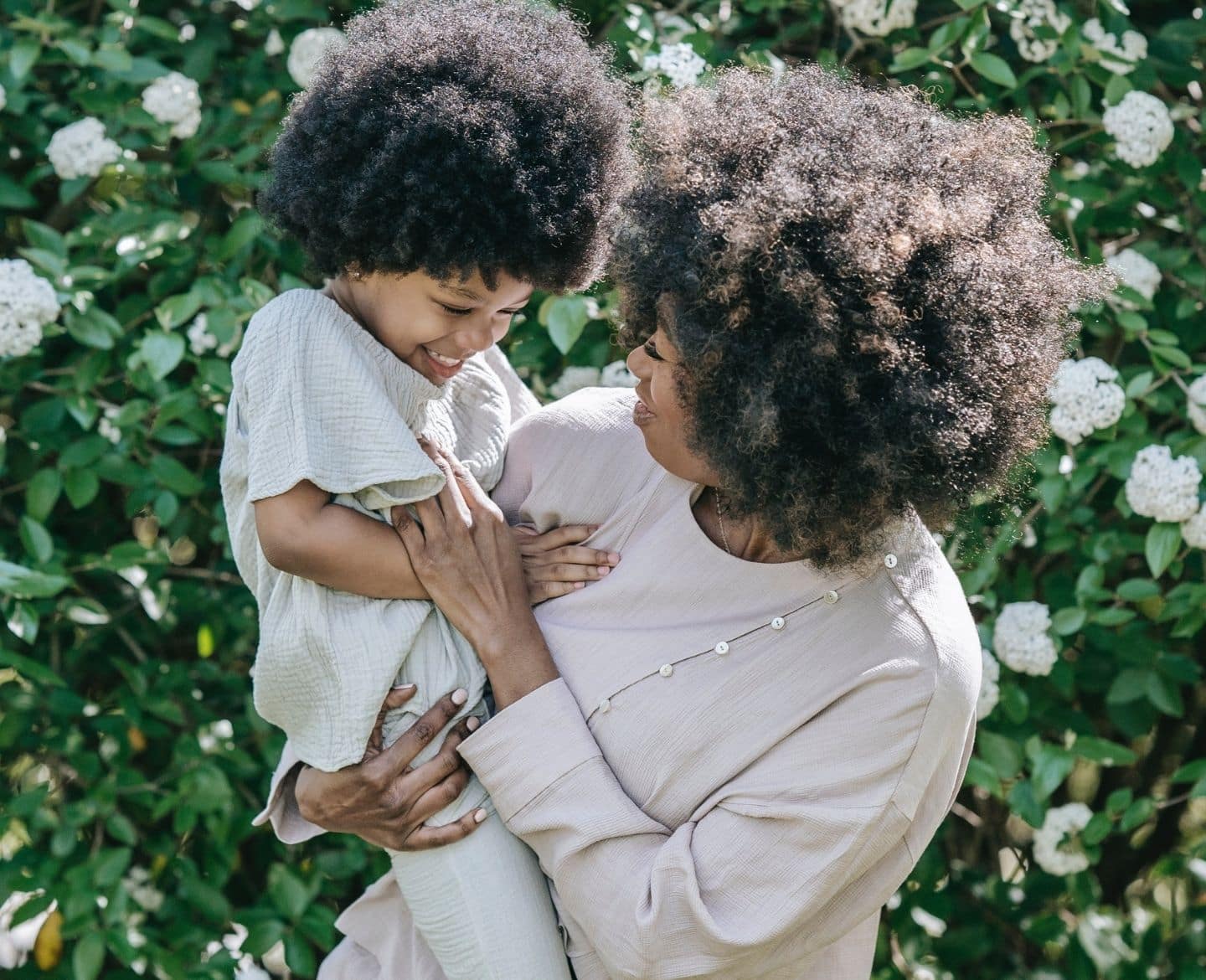 mother holding child smiling