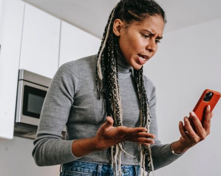 woman angry at iphone Motherly