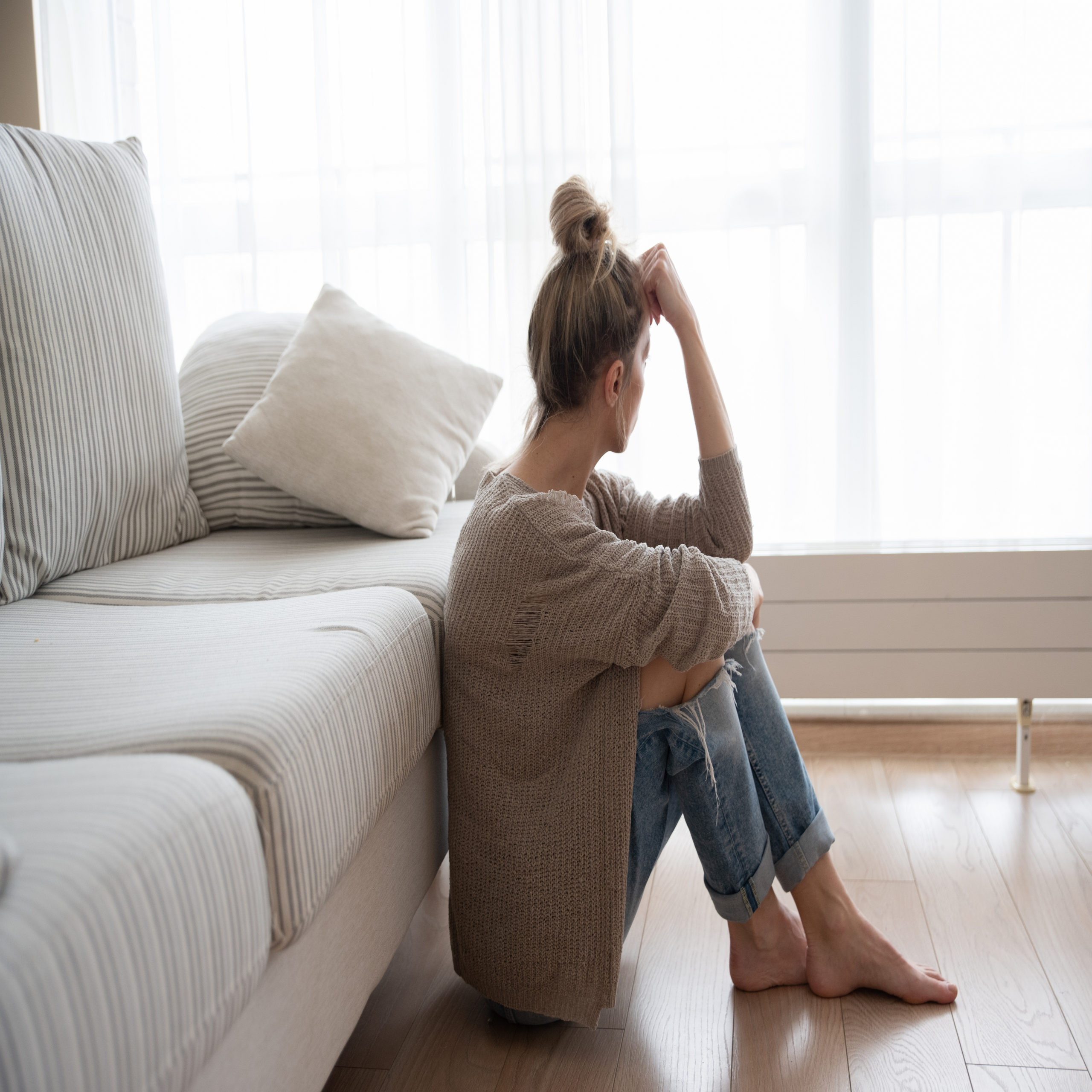 woman sitting on the living room floor