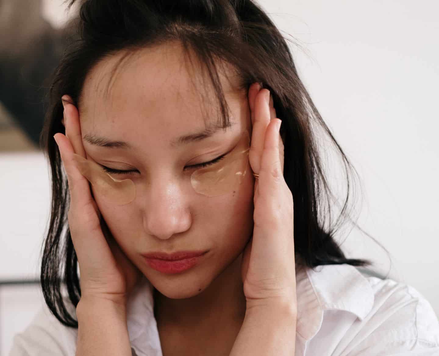 woman with hands on face and wearing eye masks