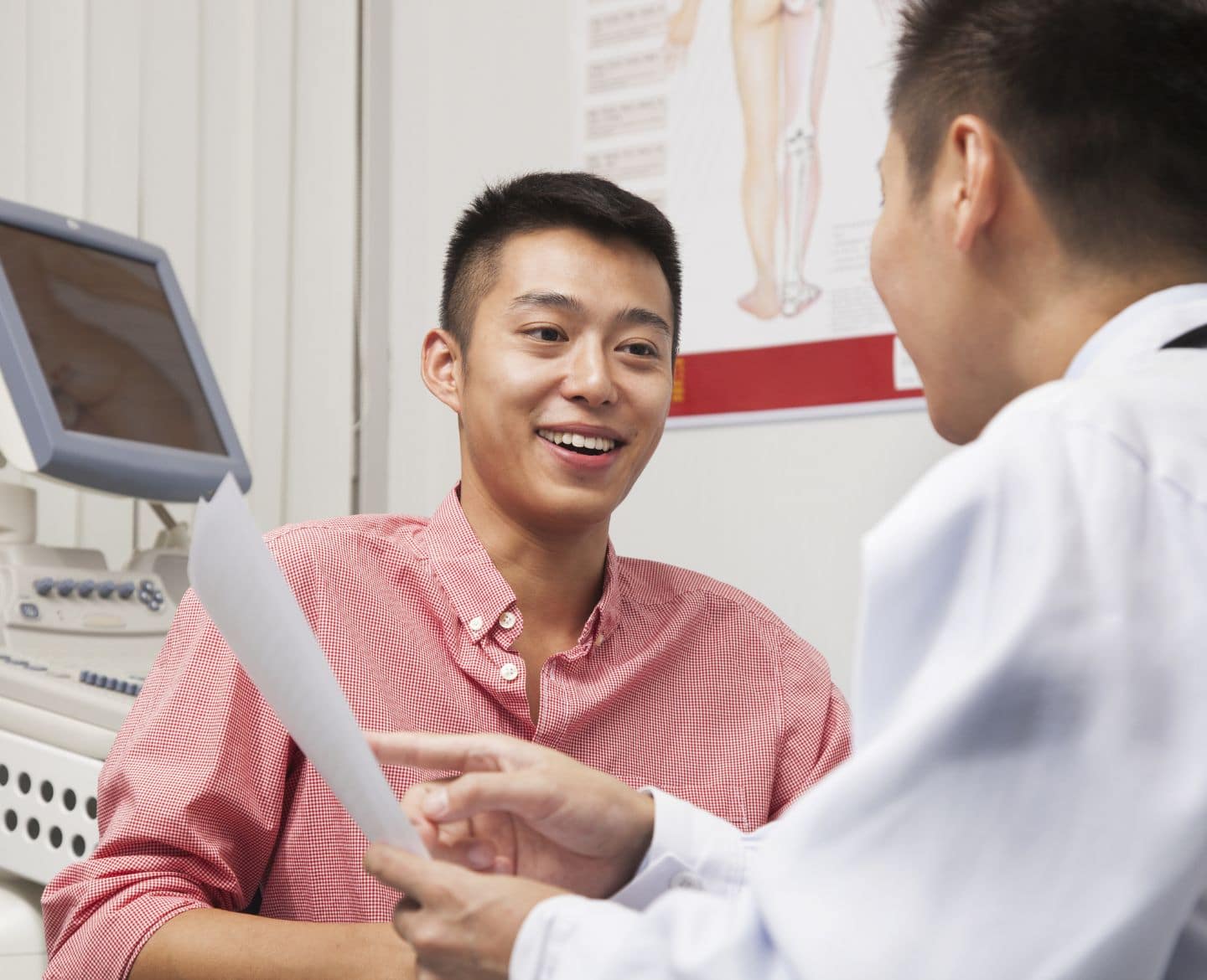 young man talking to doctor in office Motherly