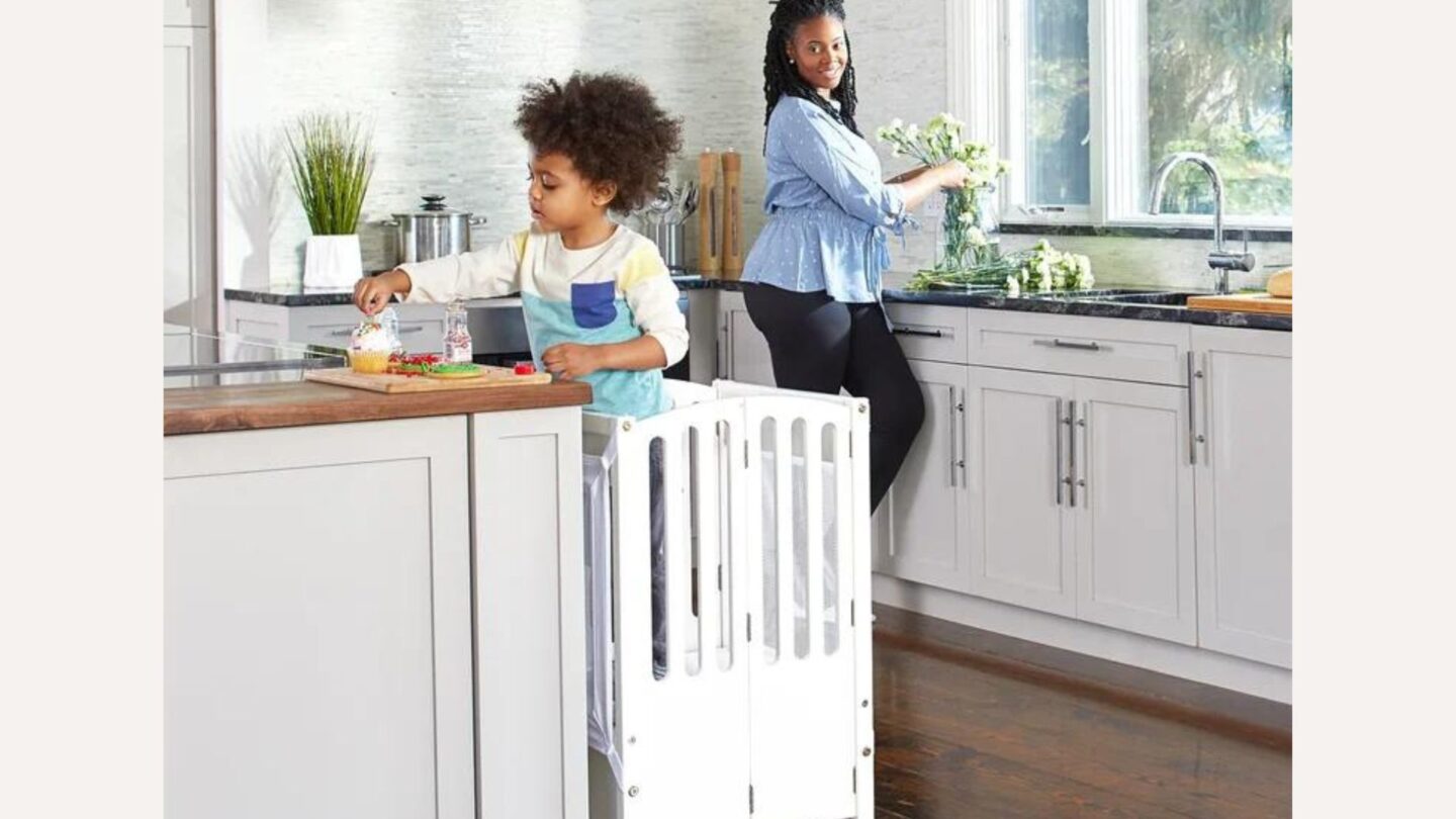 Little boy standing on a learning tower from the Wayfair sale