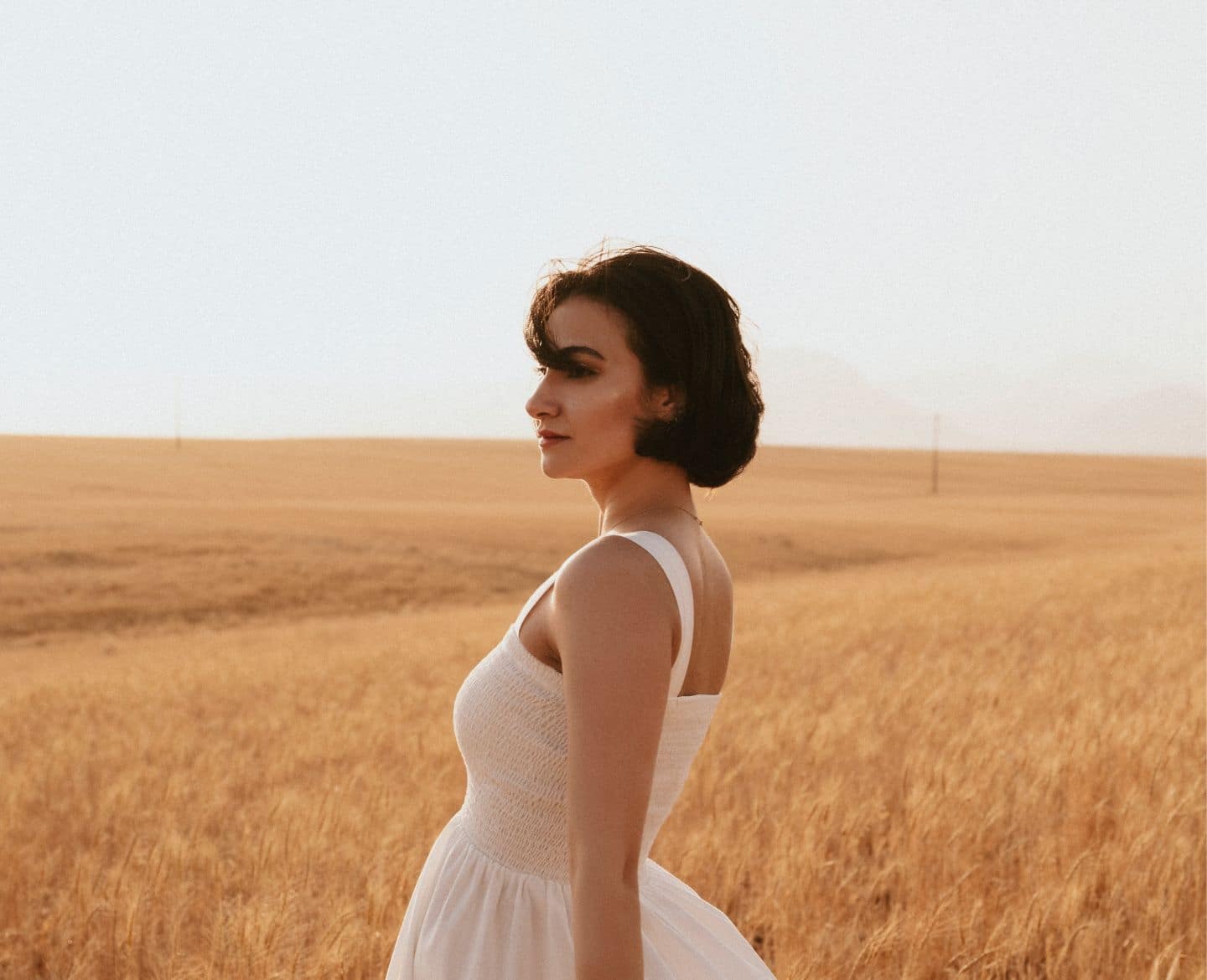 woman standing in field - chase your dreams
