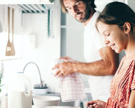 Dad and daughter in kitchen bivalent boosters for kids