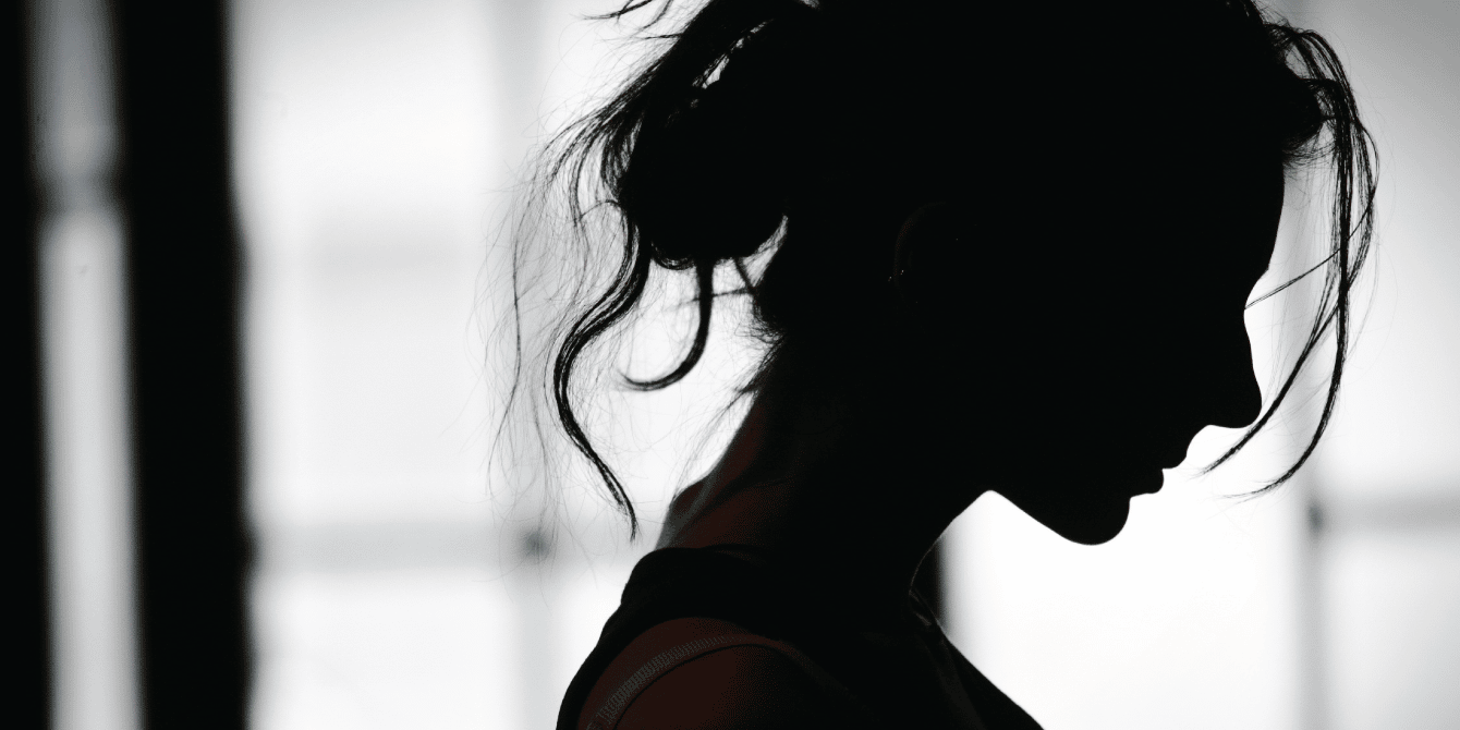 black and white photo of a silhouette of a woman - anxiety after miscarriage