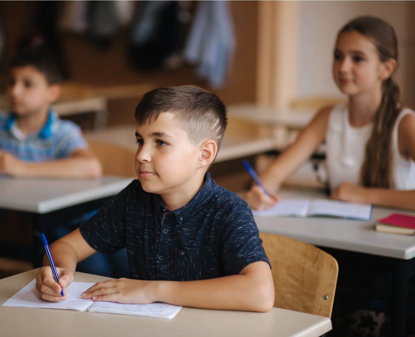 boy in classroom - covid guidance for schools