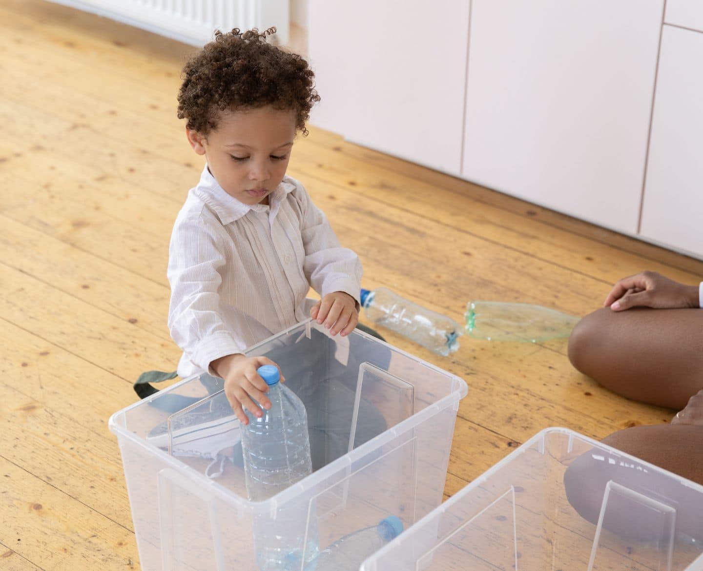 child cleaning up toys - organized kid