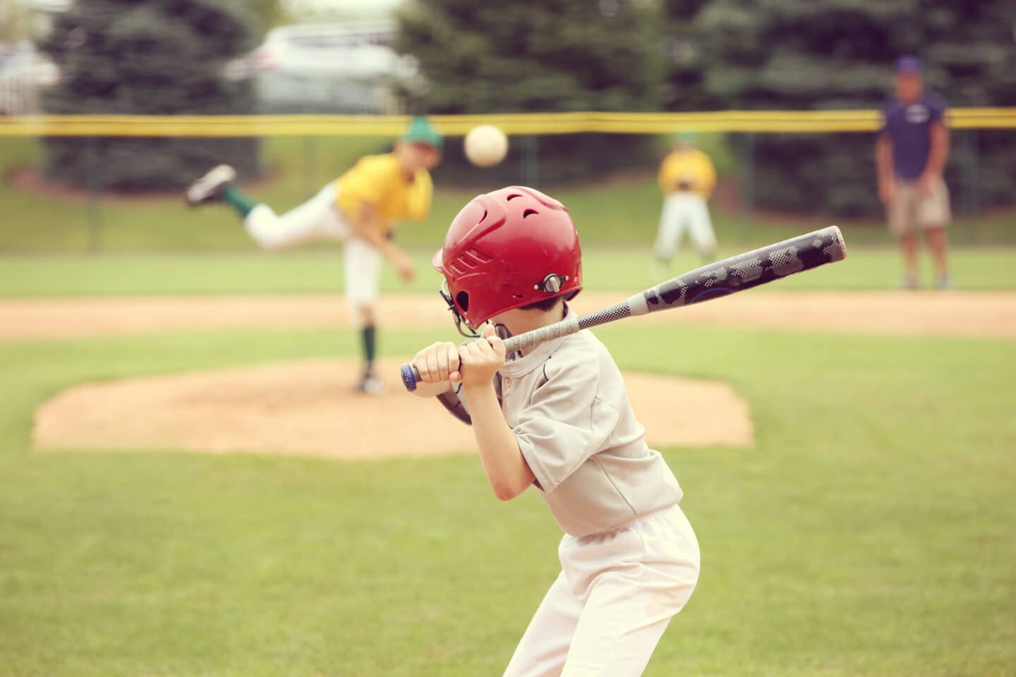 child hitting at his baseball game