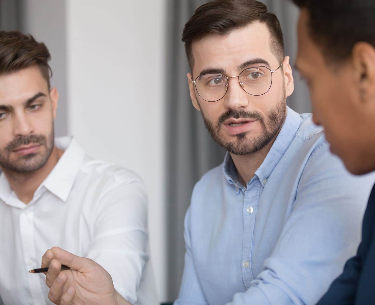 men discussing work at table - working dad