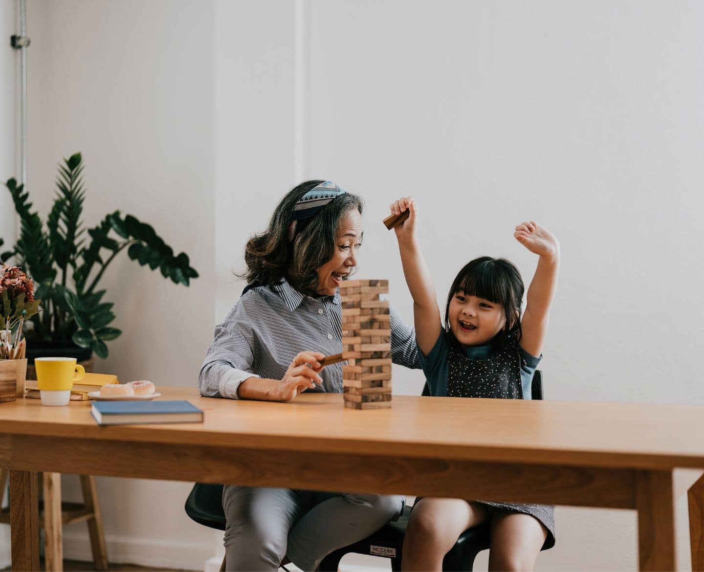 girl and grandma playing Jenga - family relationships