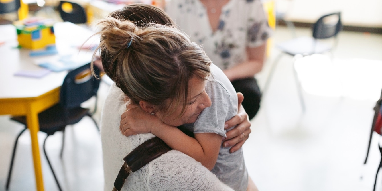 mom hugging son at drop off- mom sad on the first day of school