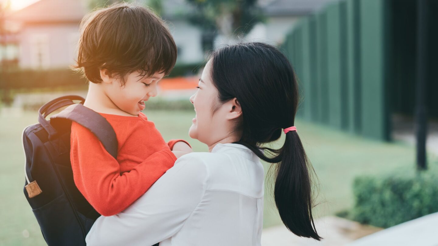 mom hugging child at school drop off